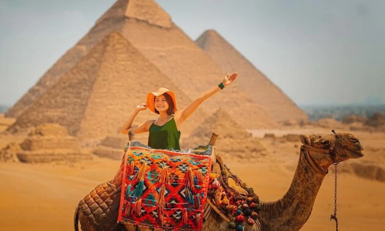A traveler enjoying a luxury desert safari in Egypt with private 4x4 vehicles, elegant tents, and golden dunes stretching into the horizon.