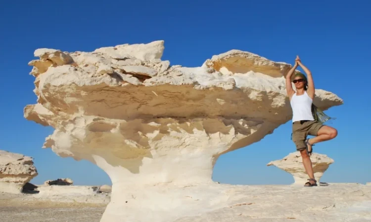 A breathtaking view of Egypt’s White Desert with surreal white rock formations and desert campers under a starlit sky.